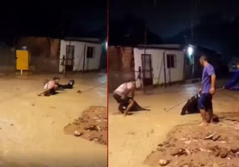 O jovem motociclista cai no buraco, escondido numa rua tomada pela água da enxurrada, e os moradores se unem para regatar tanto ele quanto a moto. Tudo dá certo. É a força da solidariedade. Foto: Gazeta Web