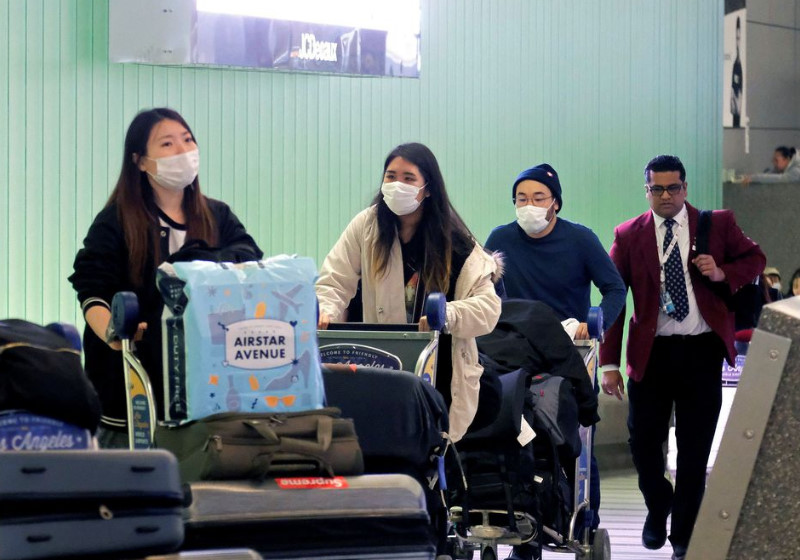 Chineses no aeroporto - Foto: Ringo Chiu|Foto: Ringo Chiu