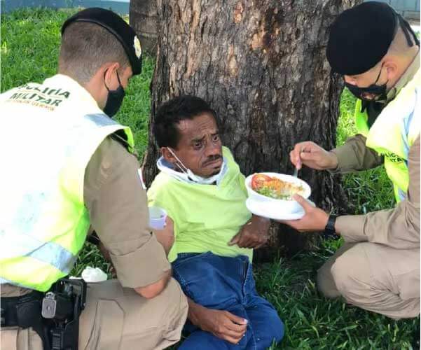 Policiais ajudam sem-teto a se alimentar. - Foto: reprodução redes sociais
