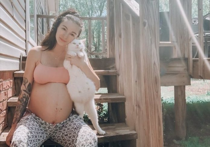 A ativista Lauren e a gatinha prenha que ela resgatou nas últimas semanas da gravidez - Foto: Reprodução/ Instagram @mama.maners