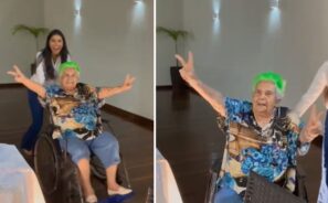 Dona Nedy apareceu toda animada, sendo empurrada em uma cadeira de rodas. Fotos: Reprodução/vídeo