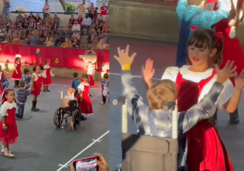 Durante a apresentação na escola, a aluna Letícia, de 6 anos, ajuda o amiguinho cadeirante Luiz Felipe na dança e o vídeo emociona internautas nas redes. Show de inclusão. - Foto: @jennifercantuaria