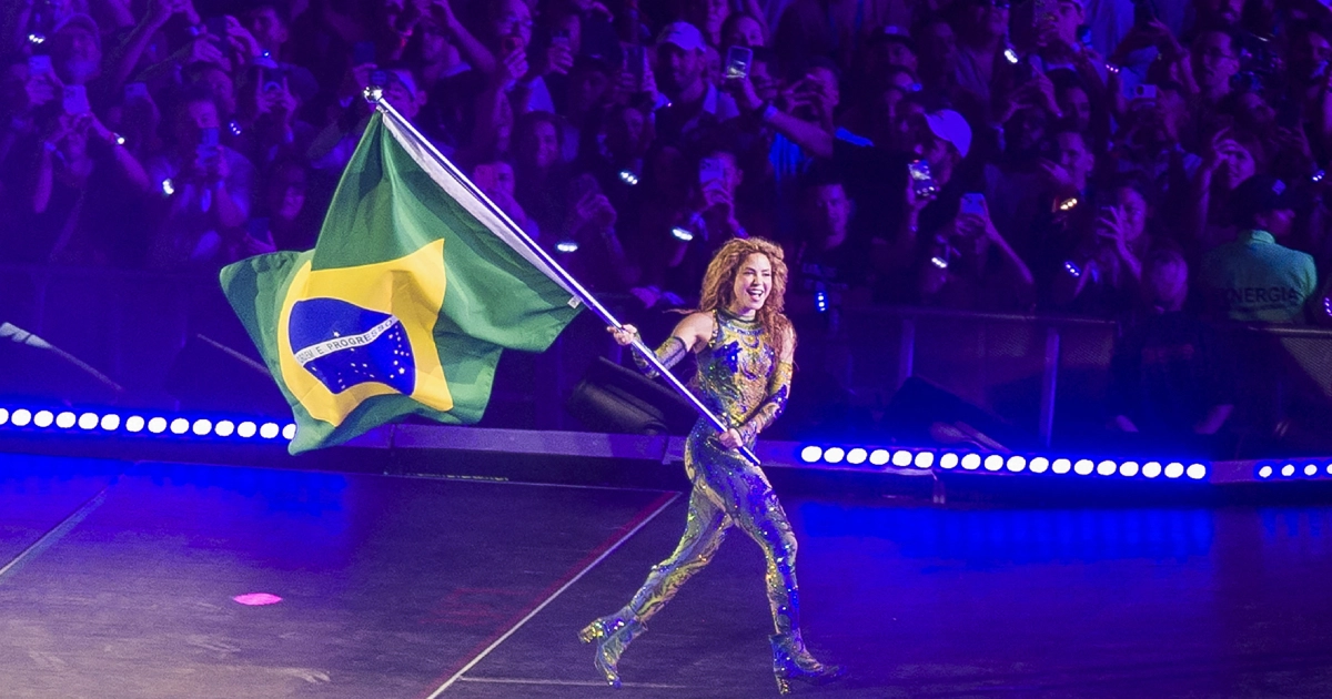 Shakira segurando a bandeira do Brasil. - Foto: Grosby/Daniel RAMALHO / AFP