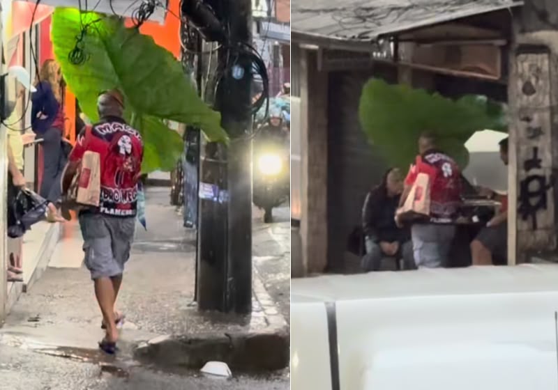 Idoso usa uma folha gigante de taioba como guarda-chuva para se proteger da chuva enquanto atravessa uma rua na Rocinha, no Rio de Janeiro. Foto: Reprodução/Instagram/@rockycria